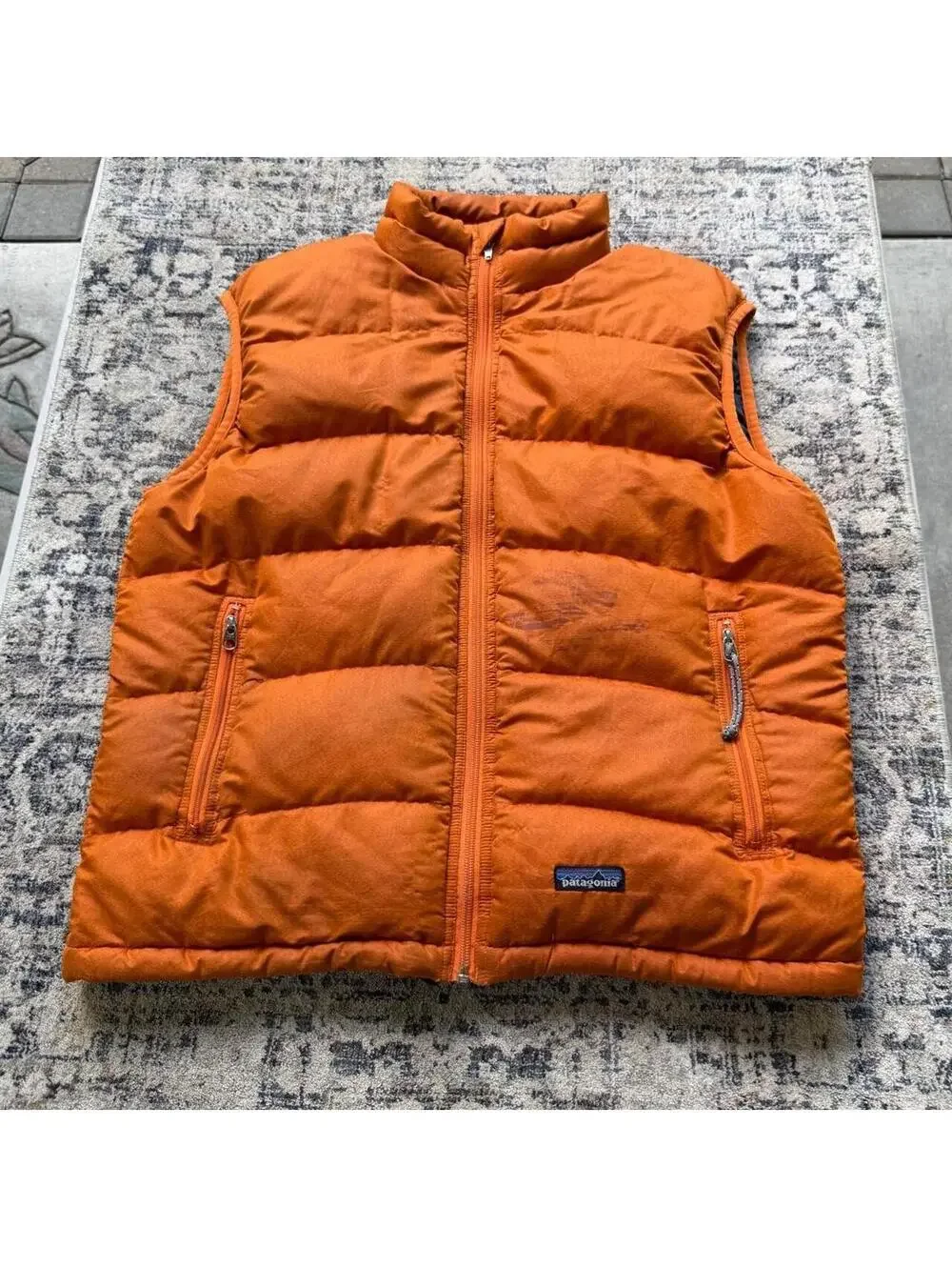 Vintage Patagonia orange puffer vest with stains